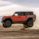 A Ford Bronco Raptor flies through the air.